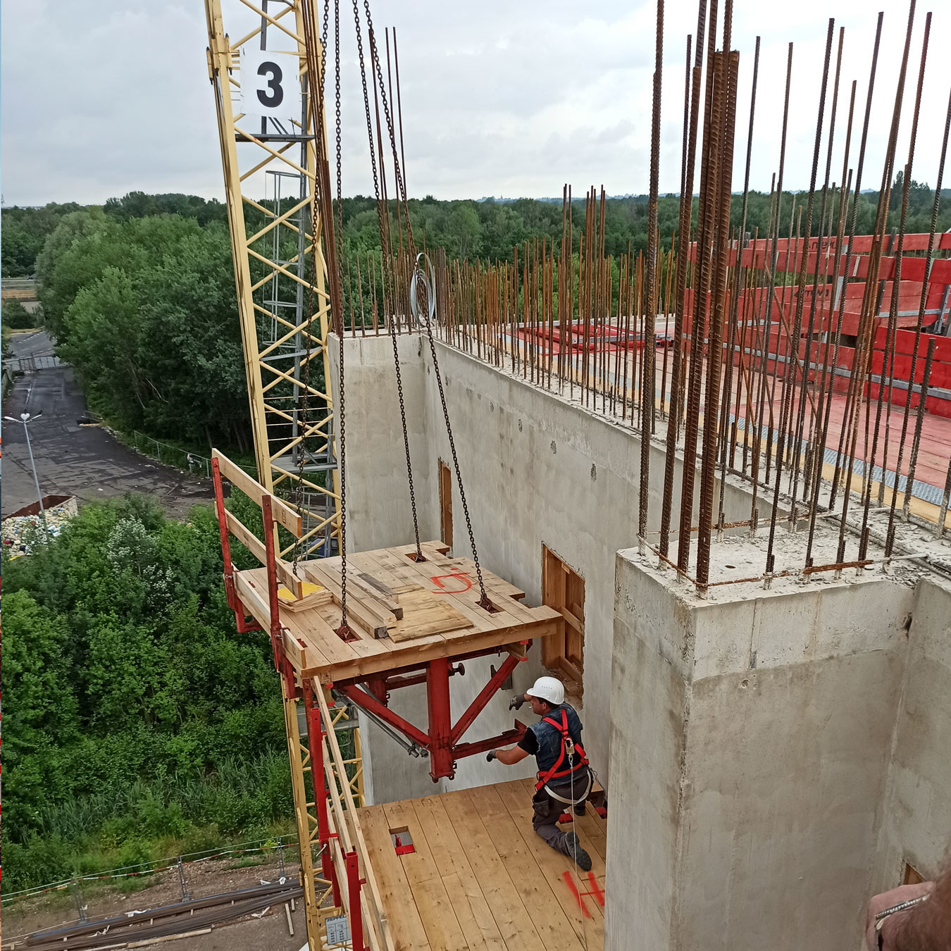 Climbing scaffolding being moved into place to support concrete construction