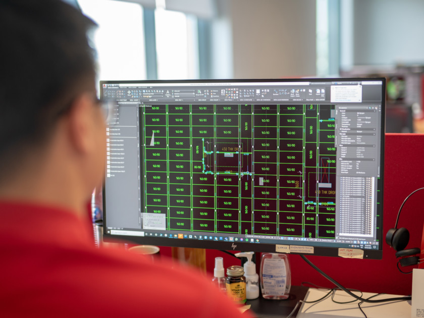 Image of man at a computer planning and designing formwork in construction